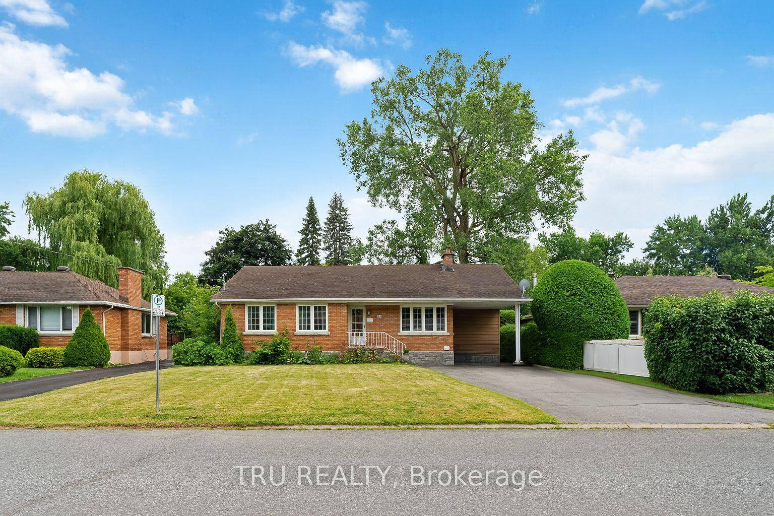 Spacious and versatile brick bungalow w 5 bedroom above ground, and 2 full bathrooms on a quiet tree lined residential street.