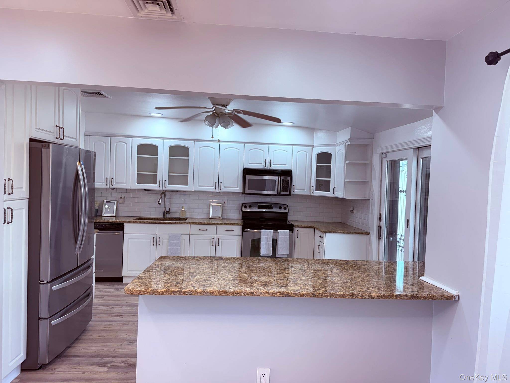 Totally renovated 4 Br, 2 bathroom, Wide line High Ranch, offering the ultimate entertaining space.