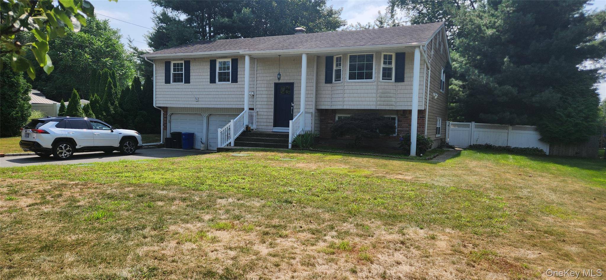 Spacious Custom Hi Ranch featuring Master Bdrm with Full Bath and Walk in Closet, 2 additional Bdrms up, Updated Main Bath, Hardwood Floors on upper level.