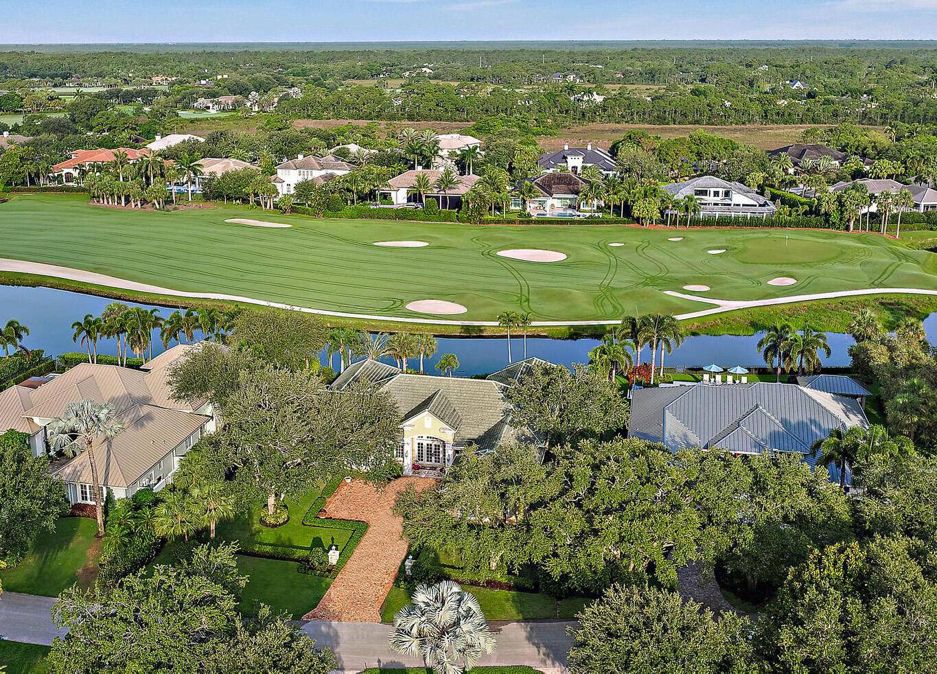 Expansive water and golf views overlooking the 2nd hole of the Pete Dye Championship golf course in one of the finest gated golf communities in Palm Beach County.