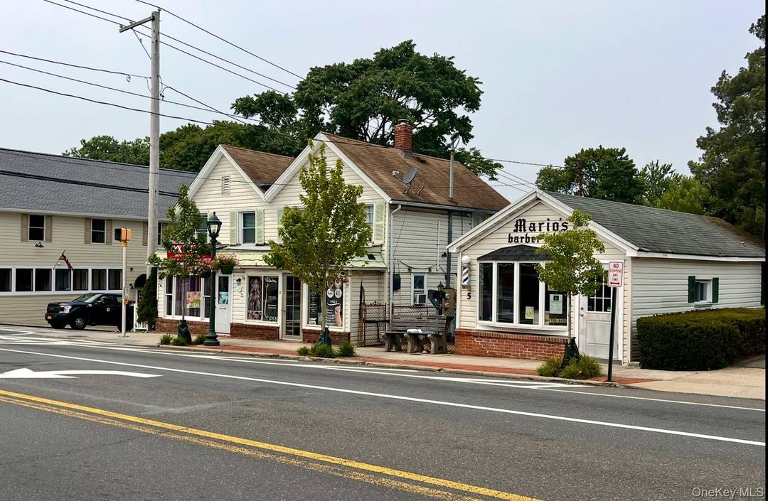 Investment opportunity ! Two story frame building with two retail stores on the first floor and two apartments on the second floor.