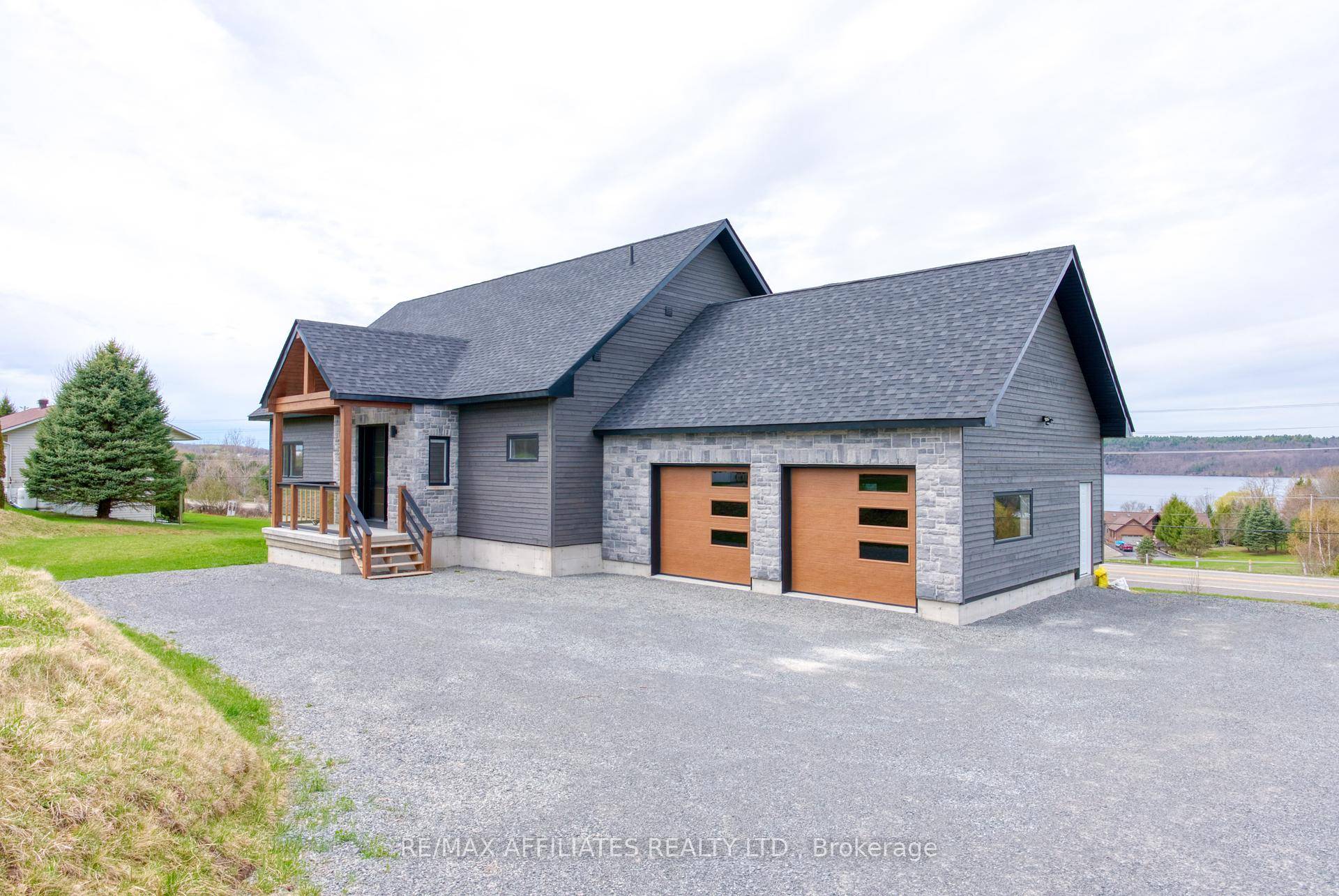 This stunning custom built home in Westport, completed in 2022, is designed with a focus on high quality materials and thoughtful design elements, offering a sophisticated lakeside living experience.