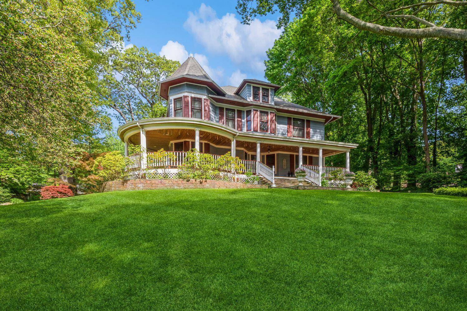Nestled within the storied Red Spring Colony of Glen Cove, 110 Red Spring Lane is a masterfully restored Queen Anne Victorian that exudes timeless elegance and refined Gold Coast charm.