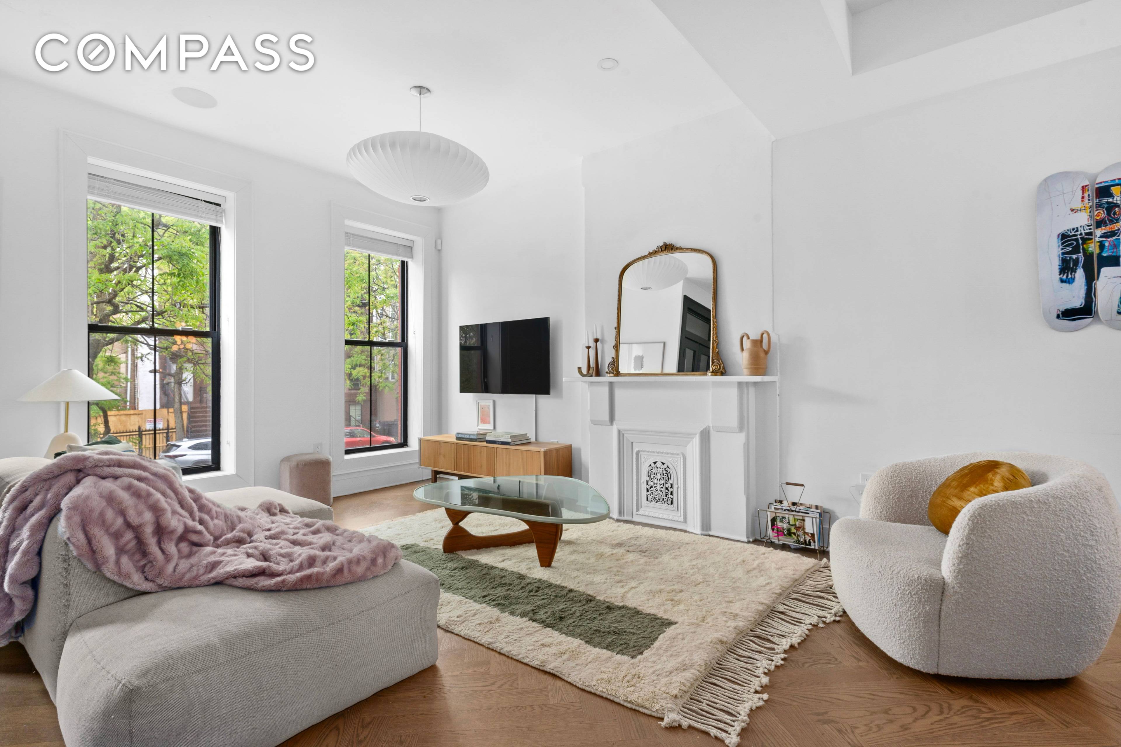 Originally built in 1910, this beautifully renovated two family townhouse blends timeless charm with modern luxury.