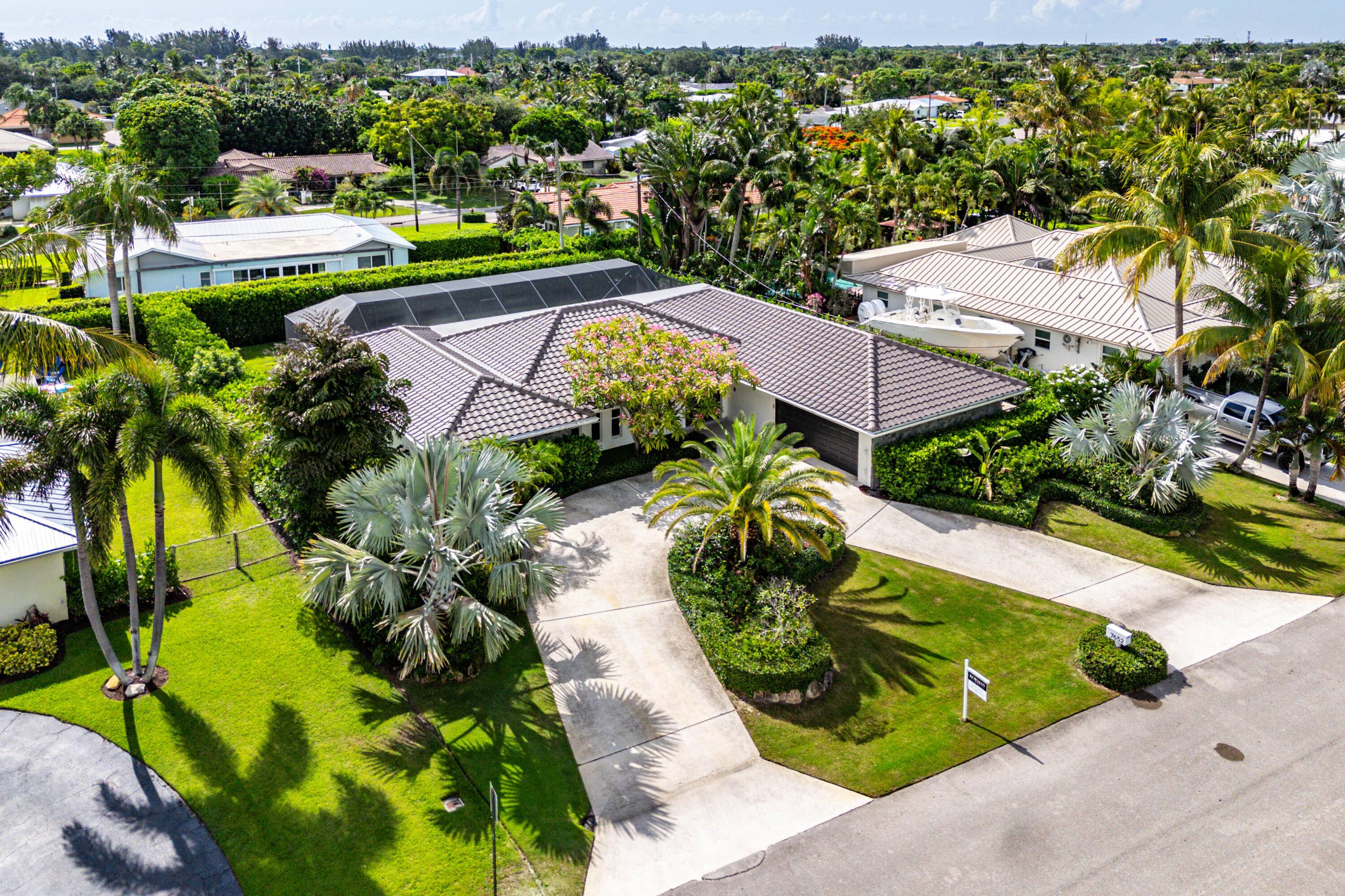 Welcome to 7652 Palm Road a meticulously maintained 4 bedroom, 3 bath pool home located in the highly desirable, boater friendly community of Lake Clarke Shores.