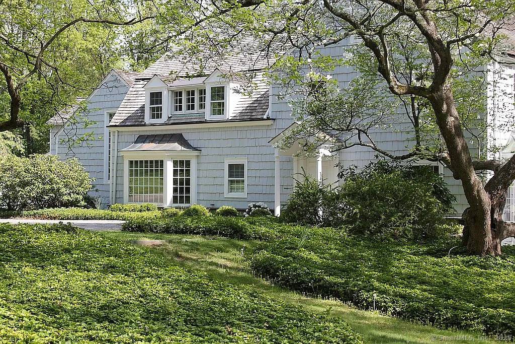 1936 Vintage Colonial Home is sited high on over 6 acres of private land in the estate section of New Canaan located in the West School District.
