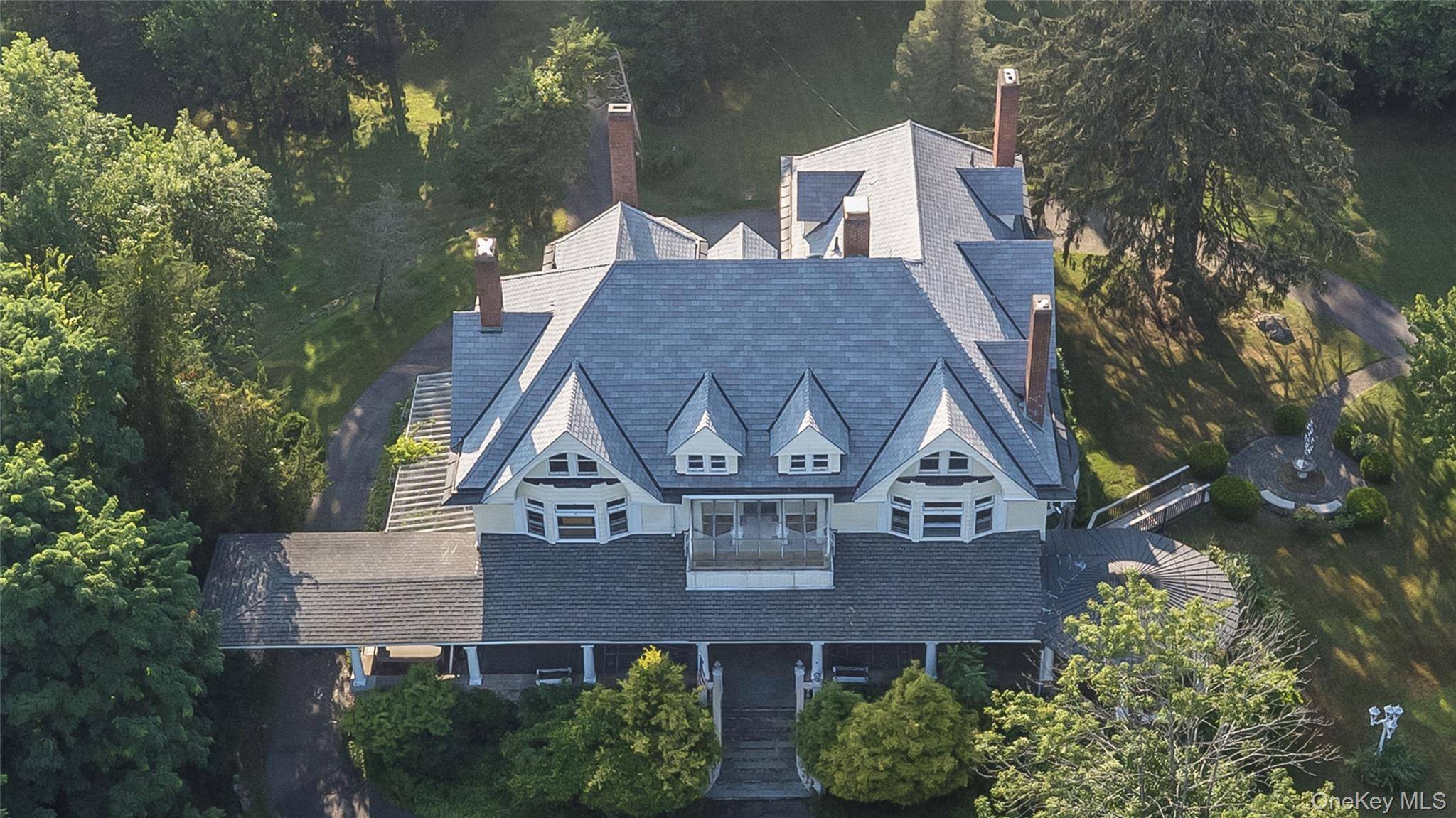 Evoking the charms of a more serene life, this Victorian center hall mansion, set on 5.