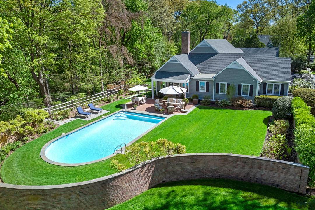 Located in the private enclave of Matinecock Farms is this totally refurbished and updated 6 bedroom state of the art Colonial.