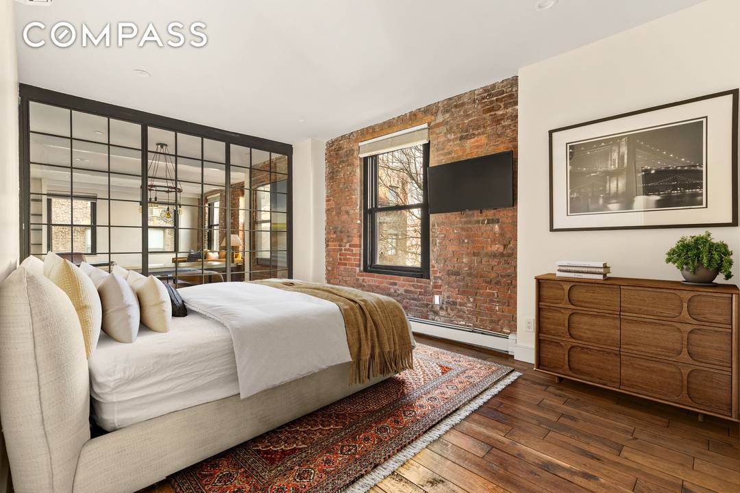 Stunning South Street Seaport Historic District Loft circa 1886 with a charming Brooklyn Bridge view and original exposed brick walls.