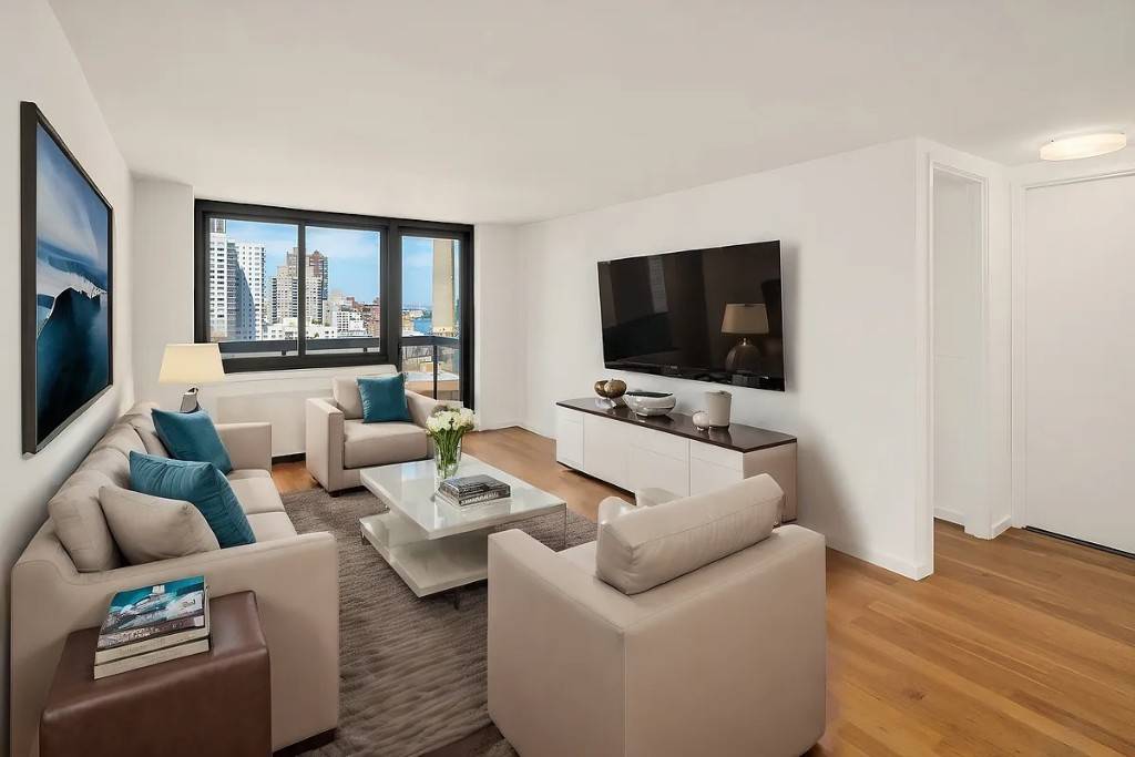 Enjoy your morning coffee on a private terrace with stunning East River and city skyline views.