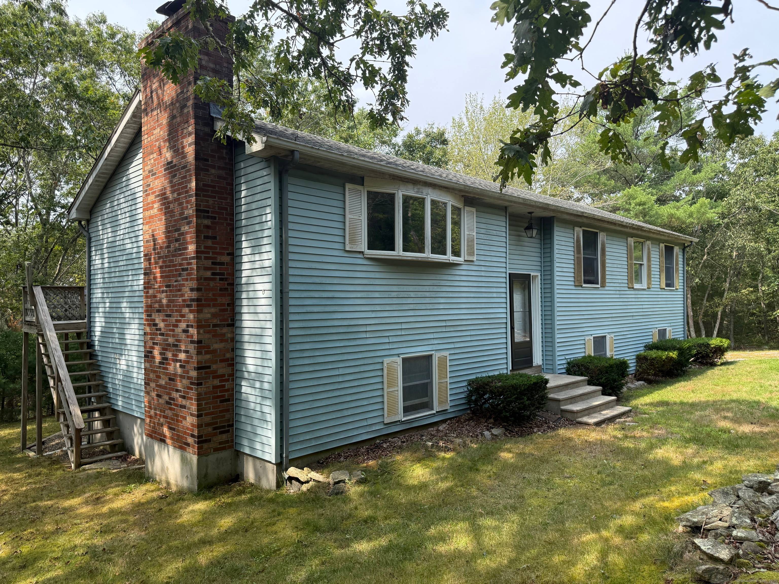 This 1990 raised ranch sits off the road on a shared driveway with 5.