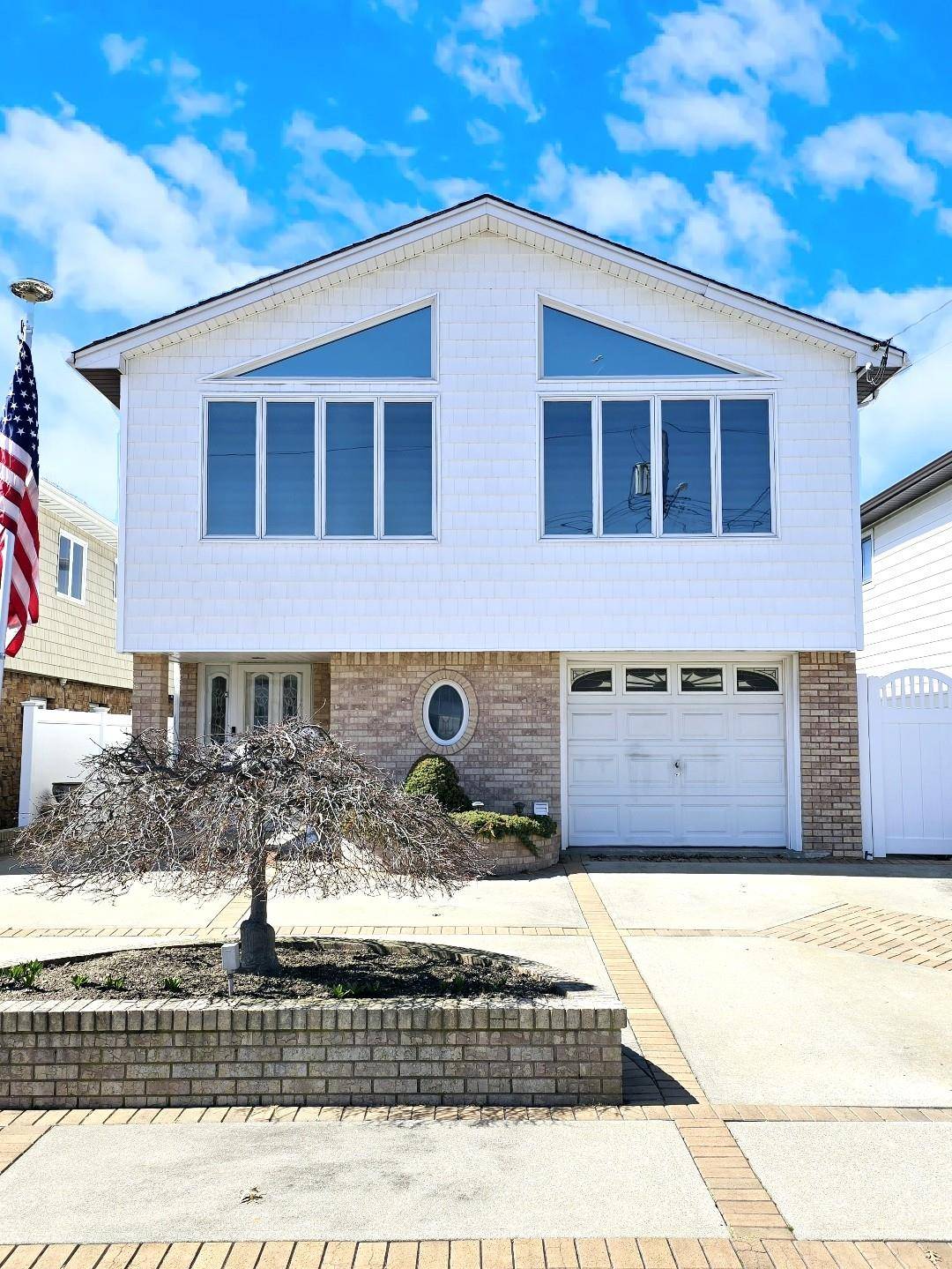 Opulently renovated New Howard Beach high ranch with four bedrooms, two bathrooms, two eat in kitchens, and two open concept living room dining rooms.