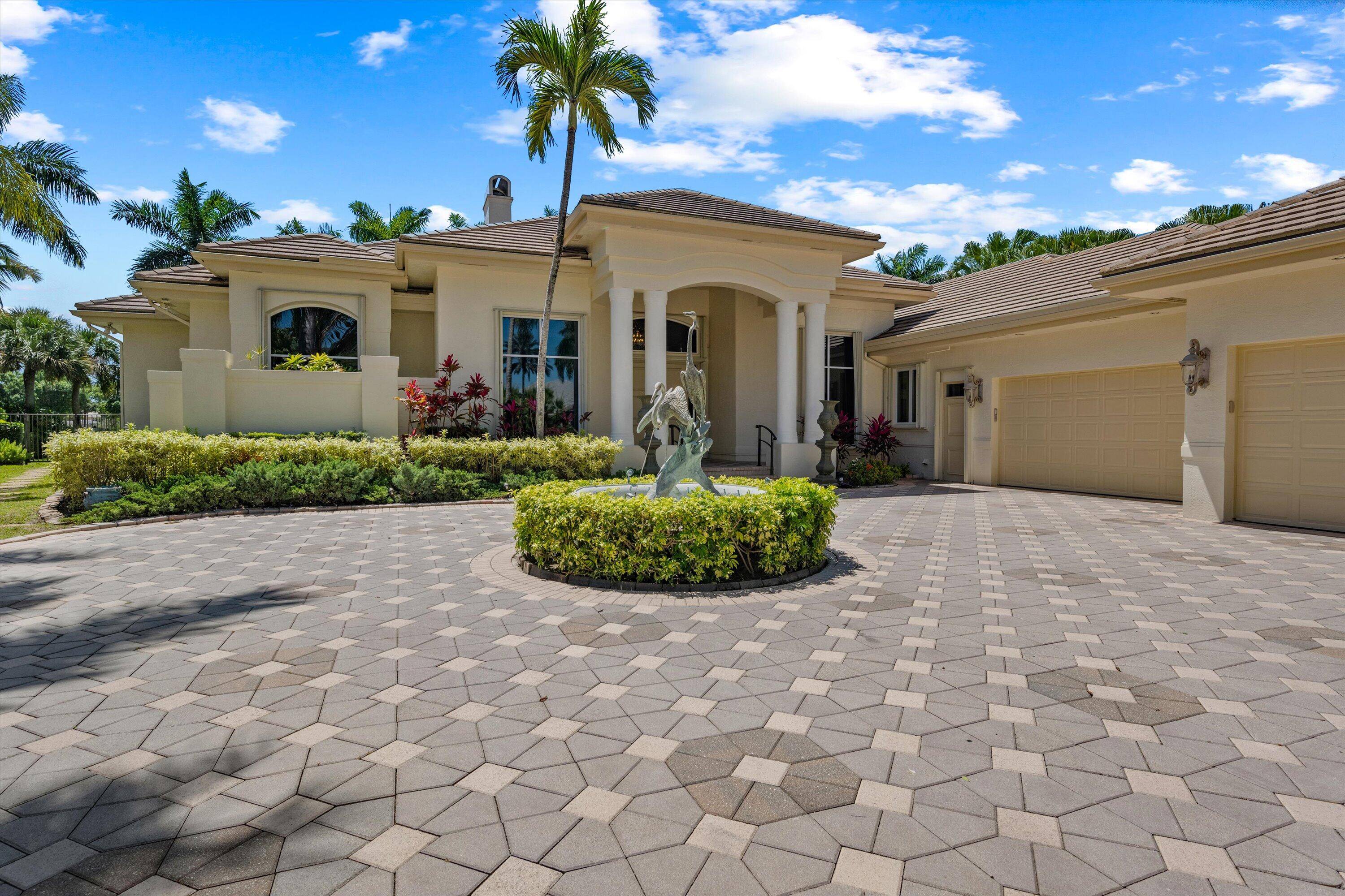Fabulous Breakers West custom home on premier cul de sac street with water and golf course views.