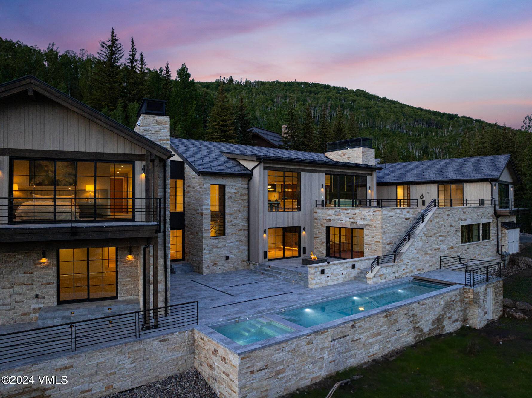 Perched at the top of Spraddle Creek Estates on over 6 acres stands Vail's newest and most spectacular custom home, boasting unparalleled panoramic views of Vail Mountain.