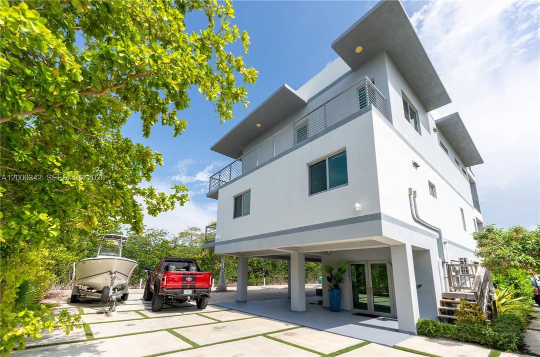 Experience unparalleled luxury in this stunning 2020 built modern home, located on a corner lot with over 200 feet of waterfront.
