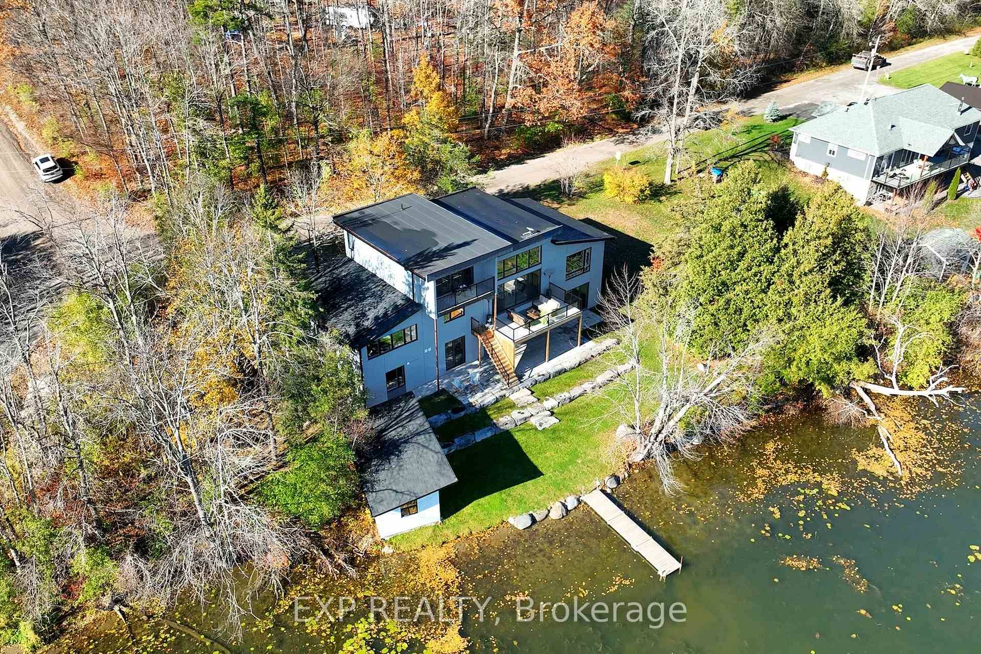 Stunning custom built lakefront home with 175 ft of private shoreline surrounded by mature trees.