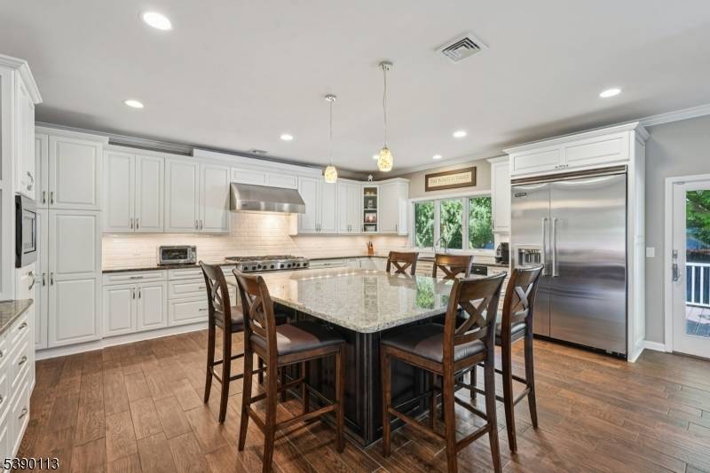 The incredible addition to this Broadlawn Neighborhood home is a showstopper a massive open kitchen, dining room, and great room that form the heart of the home.