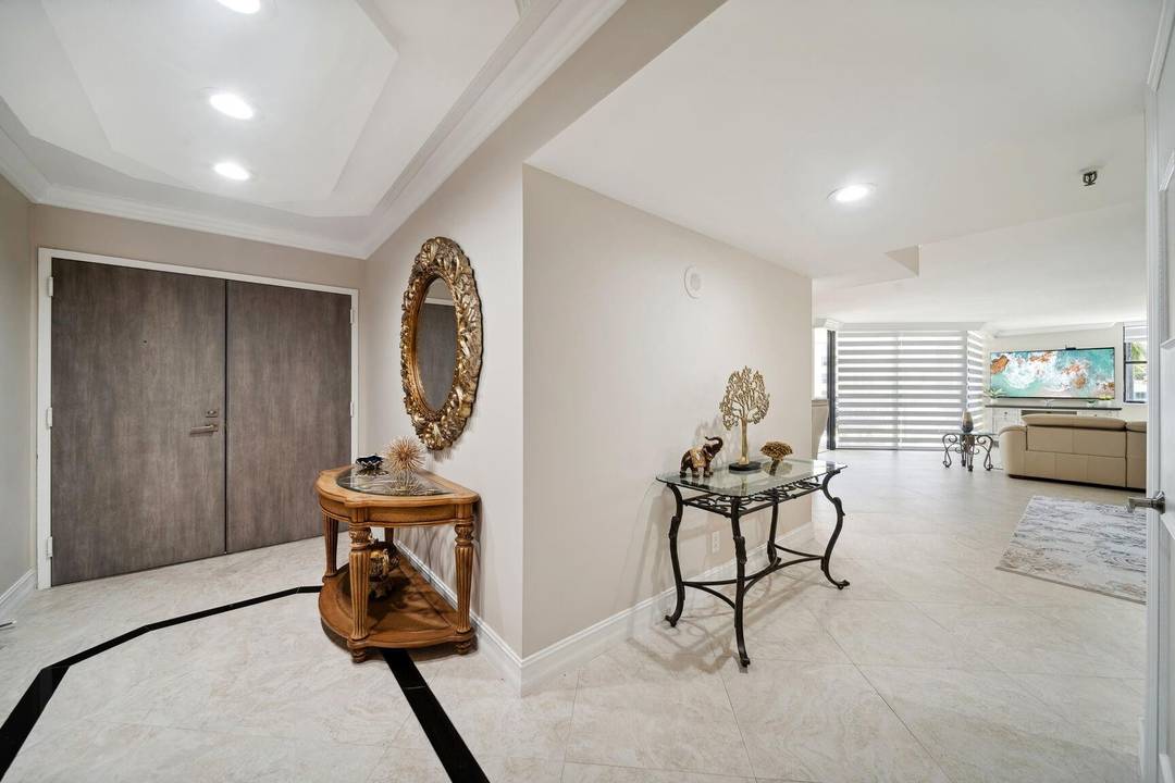 Experience luxury coastal living in this exceptional 3 bedroom, 3 bath corner residence located in the prestigious Hillsboro Ocean Club.