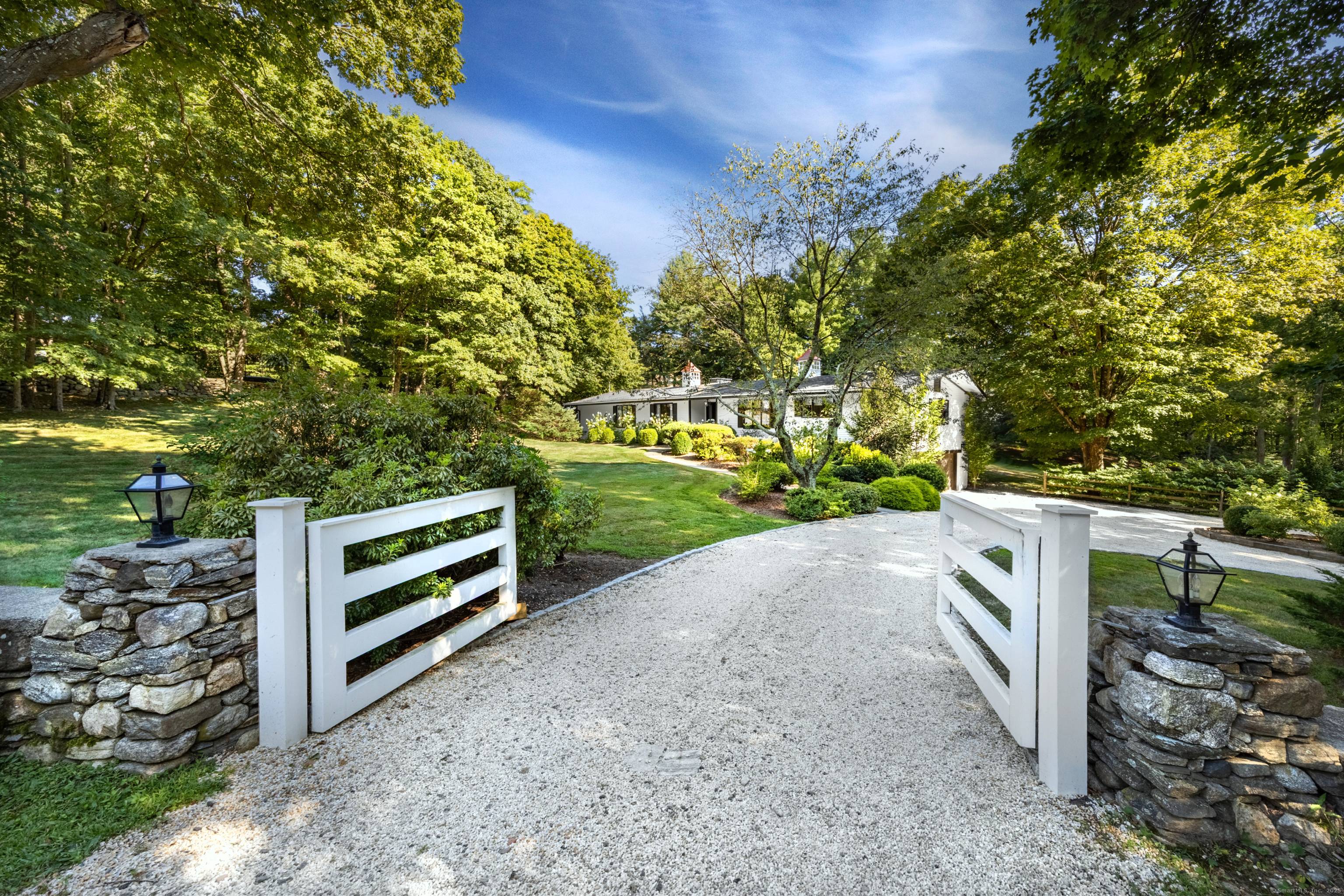 Situated on 2 manicured acres in Southport and surrounded by multi million dollar estates, this gated, European inspired country home blends timeless charm with modern elegance.