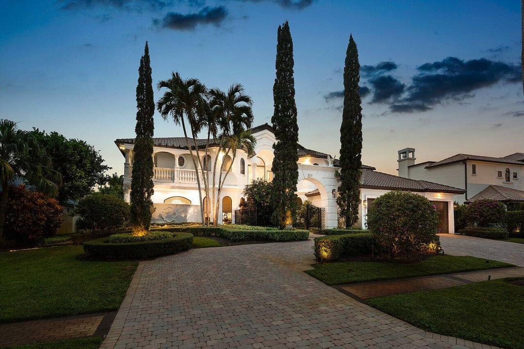 Experience breathtaking long lake views from this grand estate in the prestigious St.