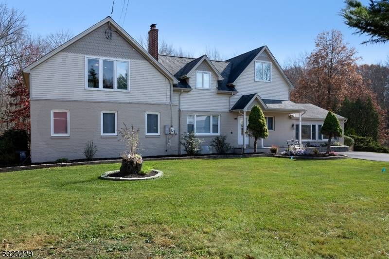 A park like lot of nearly two acres gives this airy Colonial a relaxed country feel.