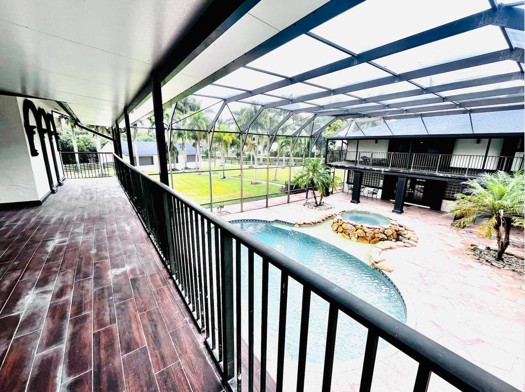 Experience the best of Wellington's equestrian lifestyle in this luxurious five acre estate located in the beautiful, tucked away gated community of Homeland a quiet, private enclave just minutes from ...