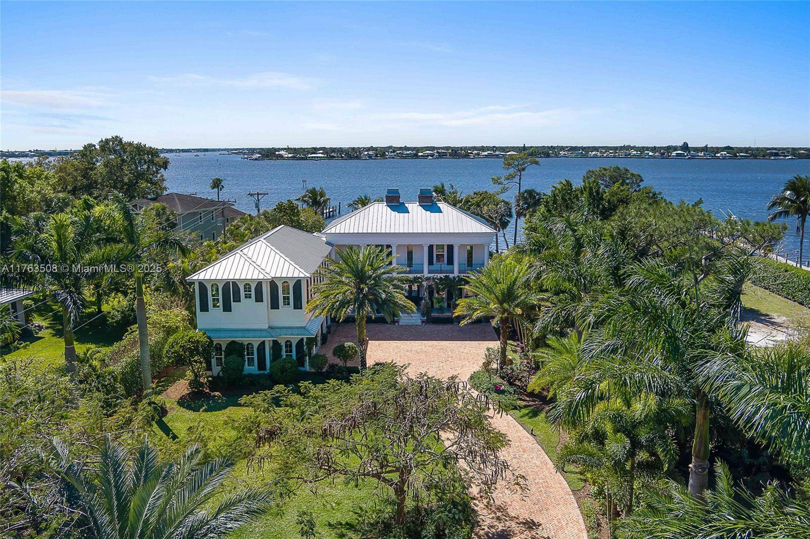 Accepting all offers. Enjoy waterfront living in this 2017 custom estate, now offered at a new reduced price.