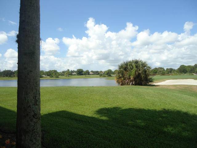 First Floor unit with magnificent view of lake and golf course from patios off living room and master bedroom, spacious laundry room, eat in kitchen, and tile throughout.