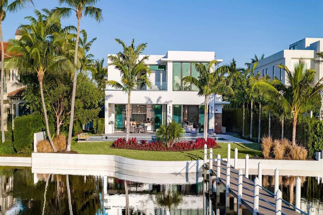 Experience refined, effortless living in this gorgeous waterfront estate in the private enclave of Hypoluxo Island.