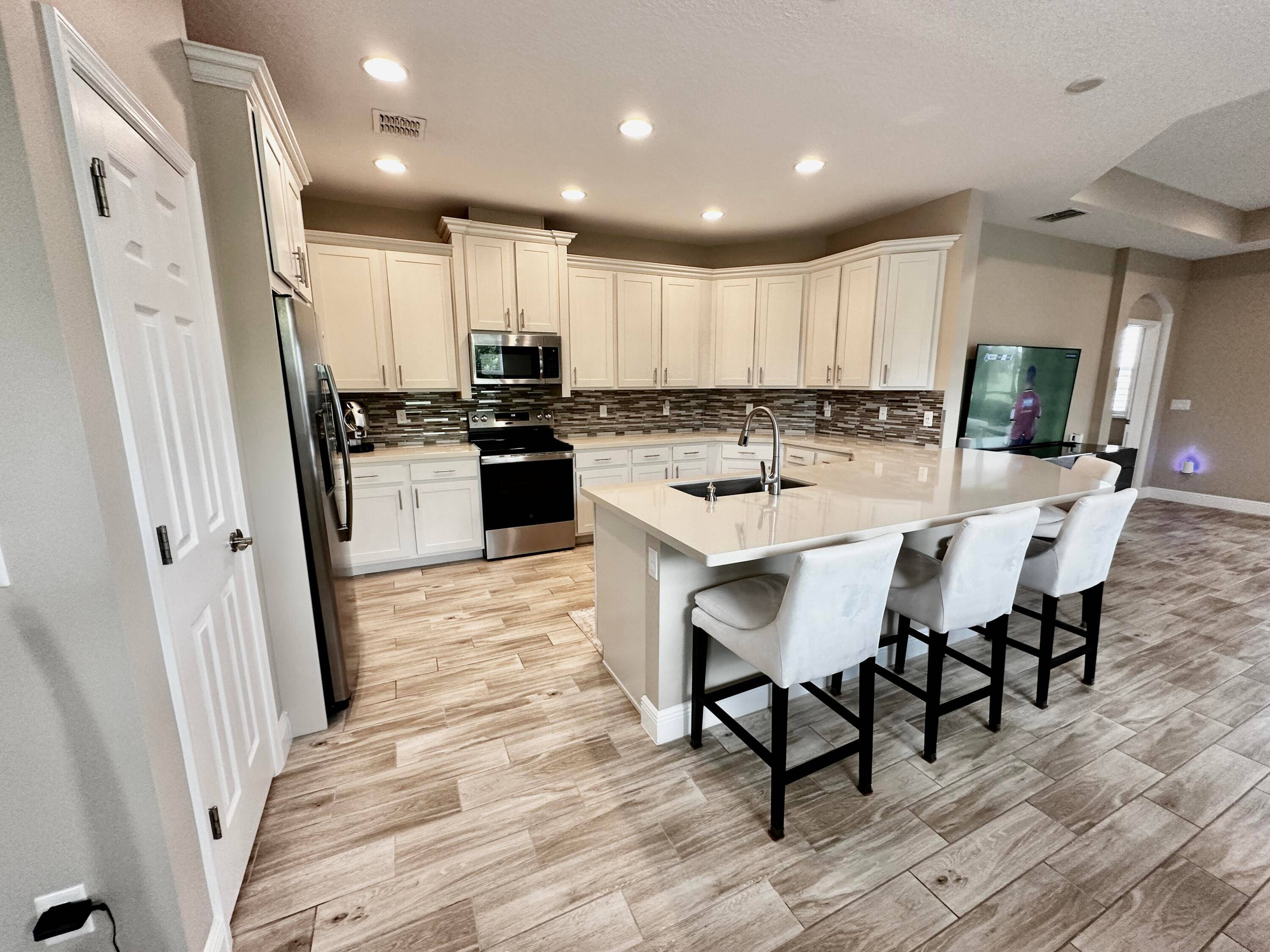 Enjoy serene lake views from this beautifully upgraded 2 bedroom plus den, 2 bathroom Villa in the sought after 55 community of LakePark at Tradition.