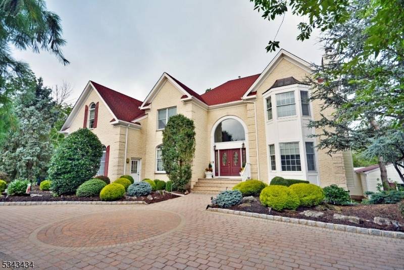 Nestled on a serene cul de sac in the sought after Warren Rise neighborhood, this elegant brick front colonial is a true retreat on 4.