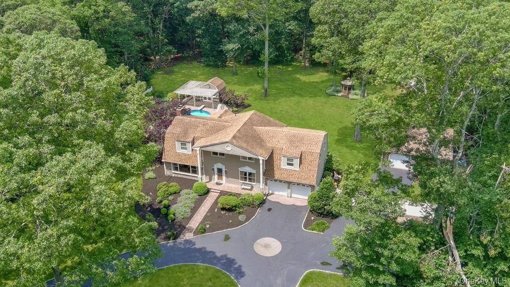 Welcome to 15 Stillwood Road, a stately Colonial nestled in the heart of Brookhaven Hamlet.