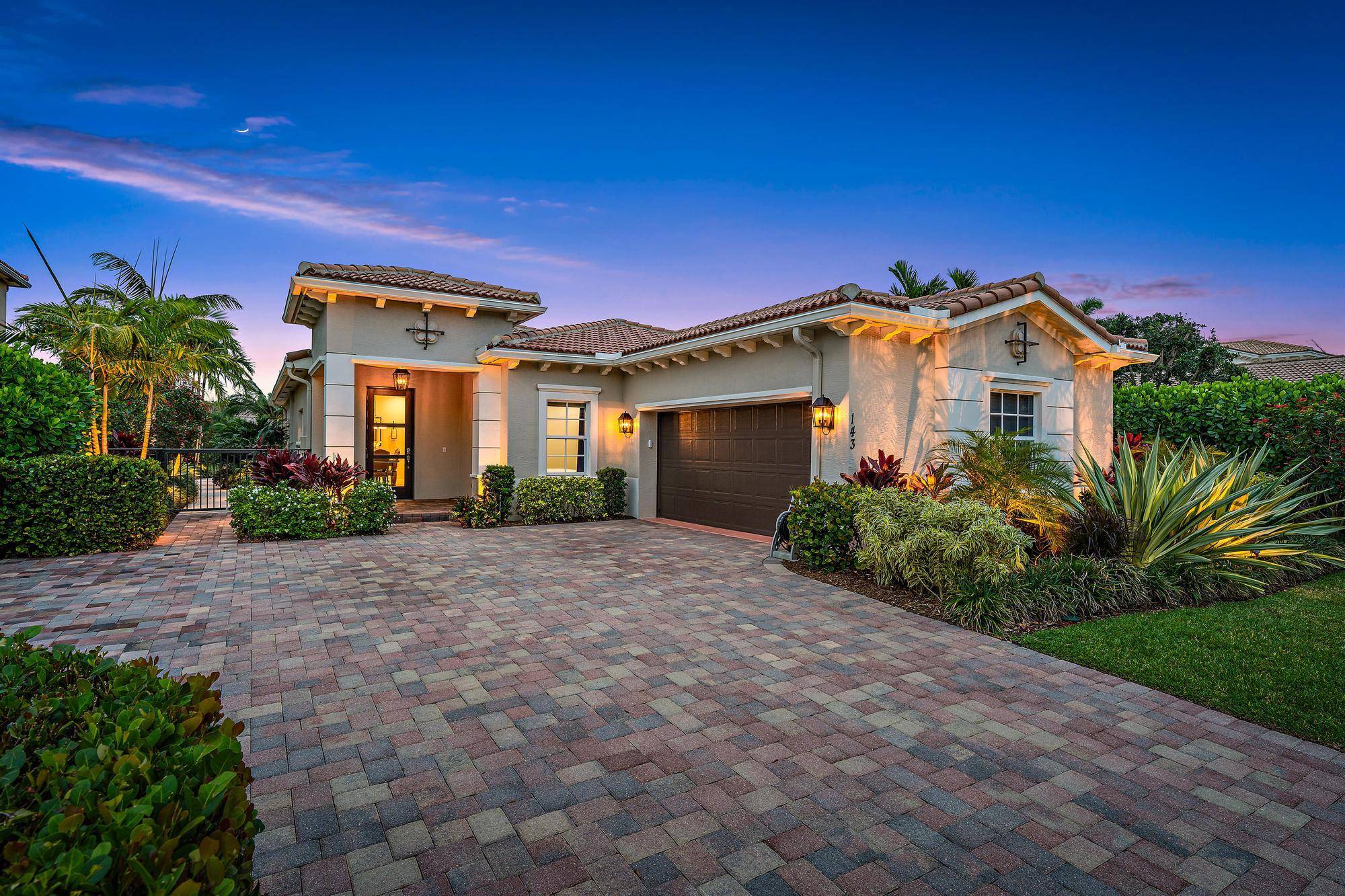 STUNNING, completely renovated CBS four bedroom, two and a half bath lakefront home in the highly sought after gated community of Rialto in Jupiter !