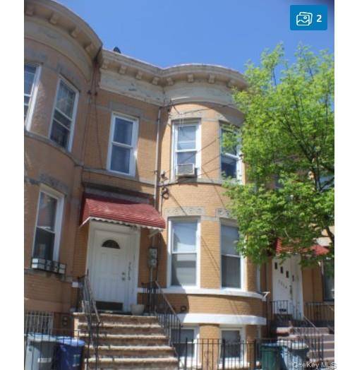 Solid attached brownstone brick 2 family home located in the heart of Glendale.