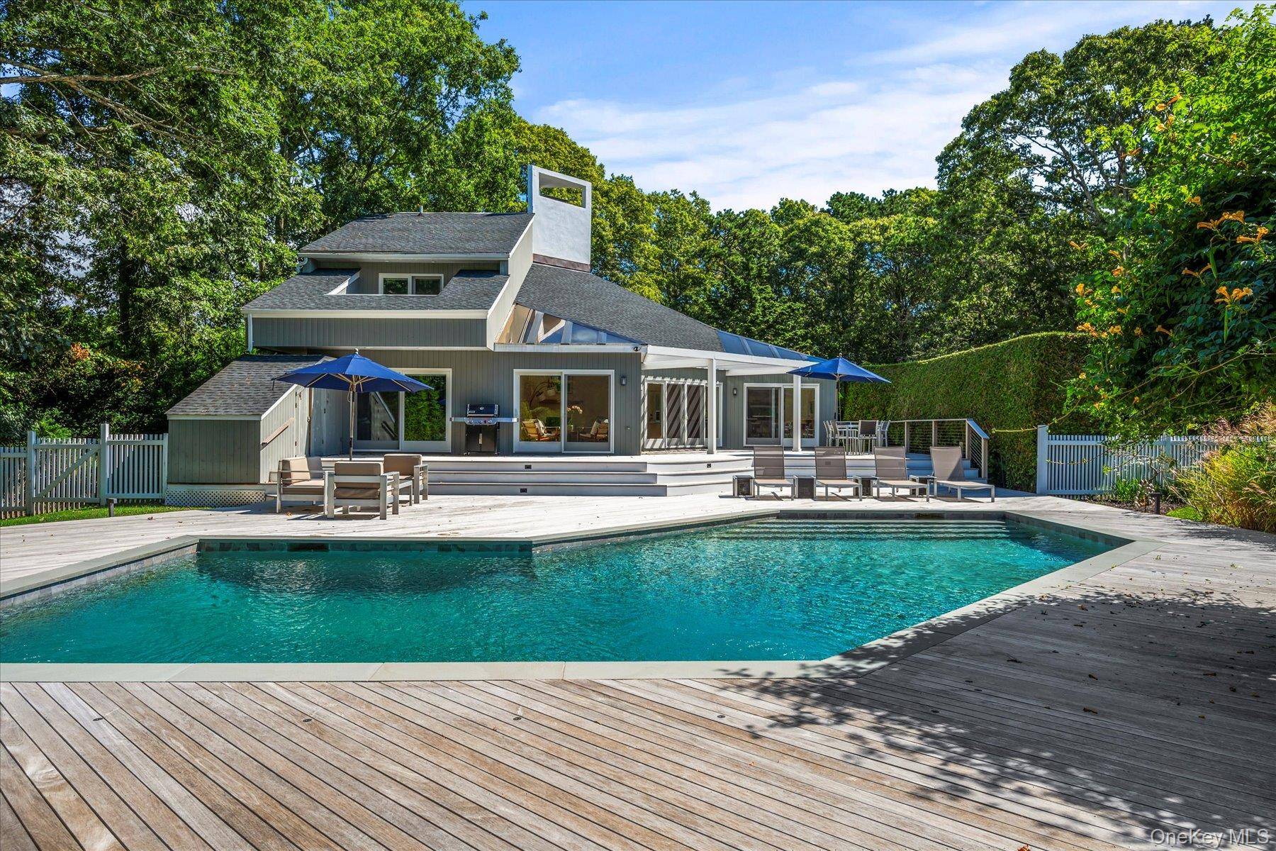 QUOGUE VILLAGE SOUTH. This sun filled contemporary home situated on a private 1 acre was meticulously renovated in 2021.