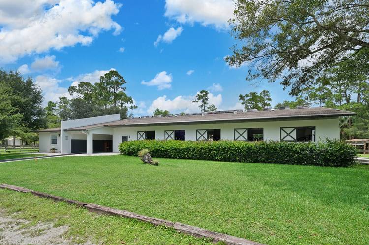 This lovely center aisle barn has ten 12x12 matted stalls, air conditioned tack and feed rooms, wash racks with hot water, irrigated paddocks and an arena measuring 100' X 210'.