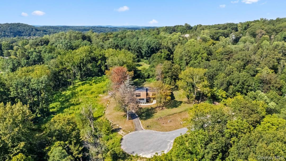 Welcome to 28 McLain, Bedford Corners NY a modern villa set on over two acres of private, level land at the end of a serene cul de sac.