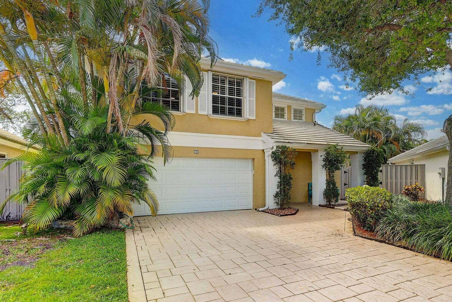 Huge yard, hurricane impact sliders, plantation shutters all around, and a 2 car garage with a driveway highlight this light filled, single family home in a renowned PGA National.