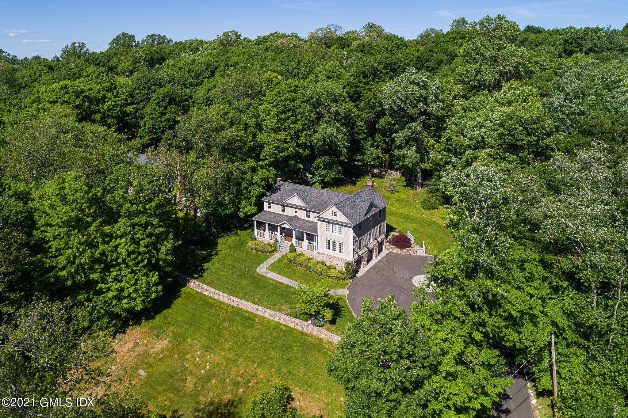 With endless tree lined and hilltop views, this classic colonial abutting hundreds of acres of Mianus River Park conservation land has been beautifully updated in 2021 and renovated in 2007.