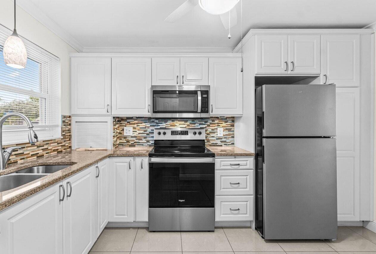 Bright and welcoming 2BR 2BA ground floor end unit featuring elegant 20'' x 20'' high gloss ceramic tile flooring throughout.