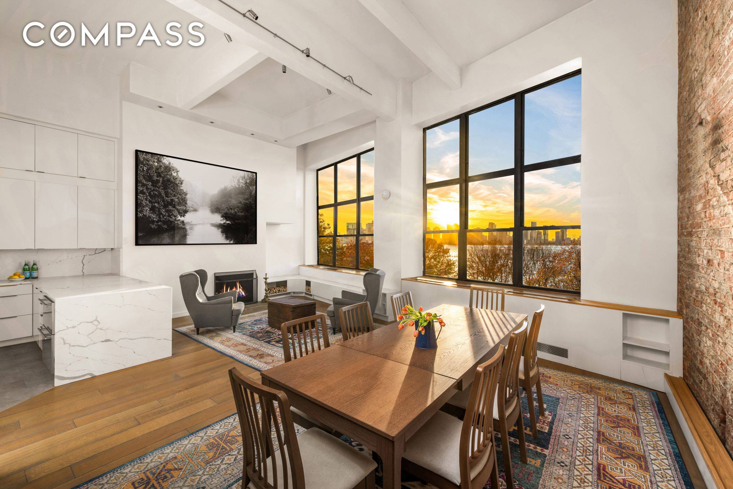 Rarely available duplex loft with 15 ft ceilings and massive windows showcasing spectacular Hudson River views in the heart of the West Village.