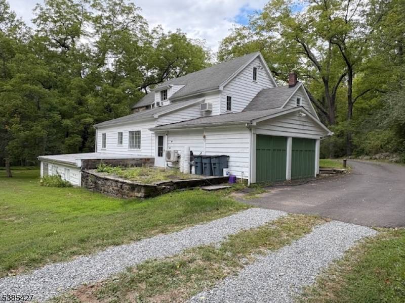 Beautiful residential setting with sprawling lawn surrounding 1920's home.