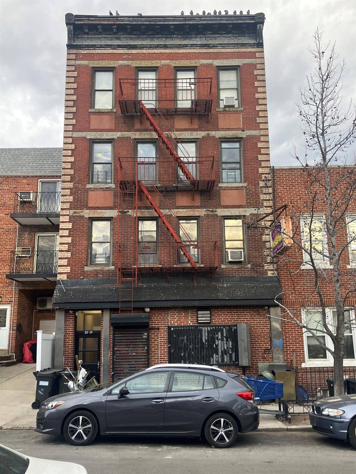6 family building with operating bar on first floor.