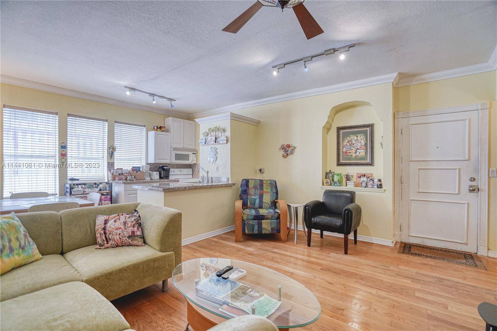 Sunlit and charming corner two bedroom condo featuring wood flooring, central a c, an updated kitchen, and conveniently located on the 1st floor.