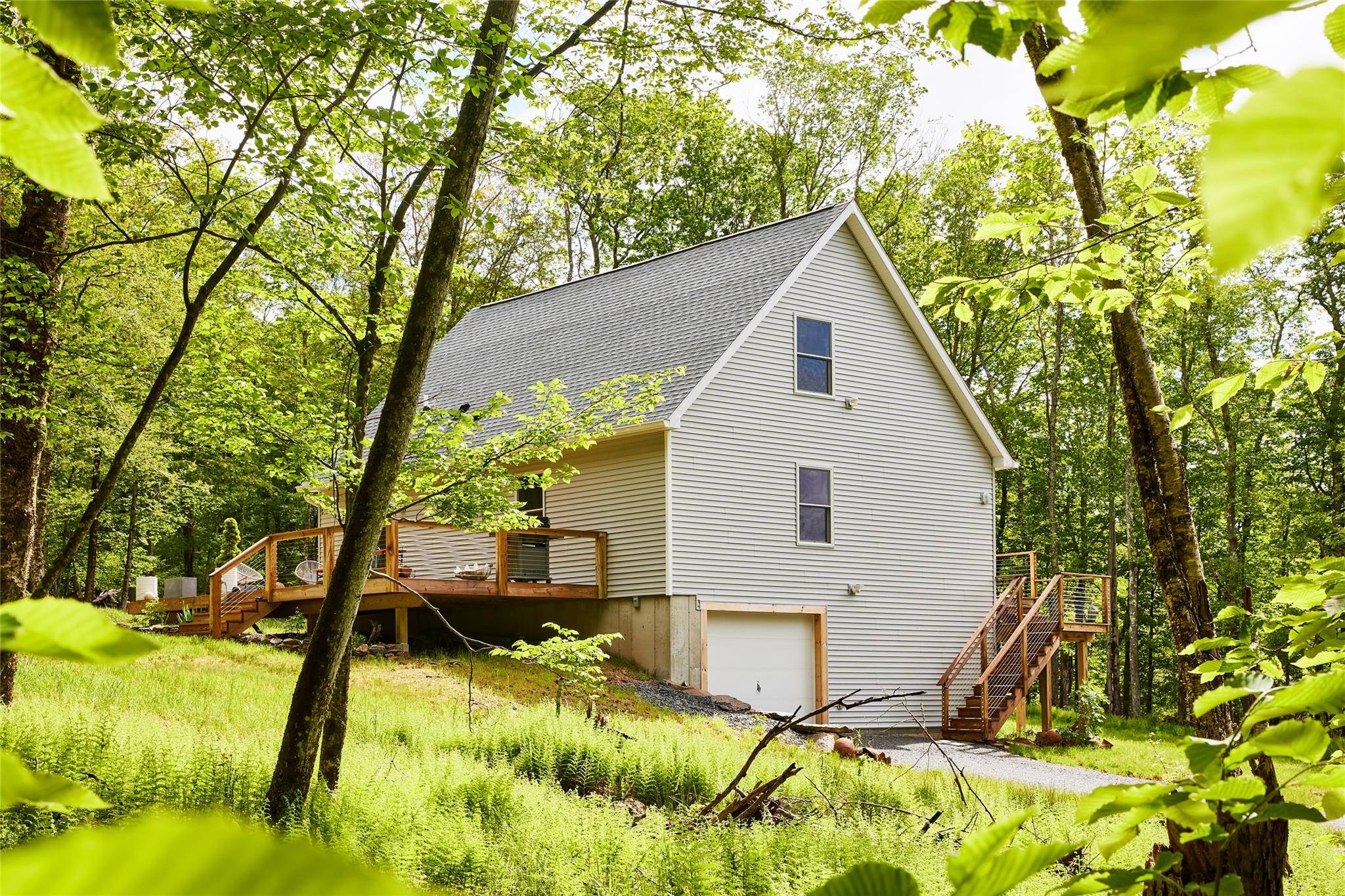 Atop a wooded hillside, on a peaceful country road just fifteen minutes from Livingston Manor s bustling Main Street, sits this charming Catskills cottage.
