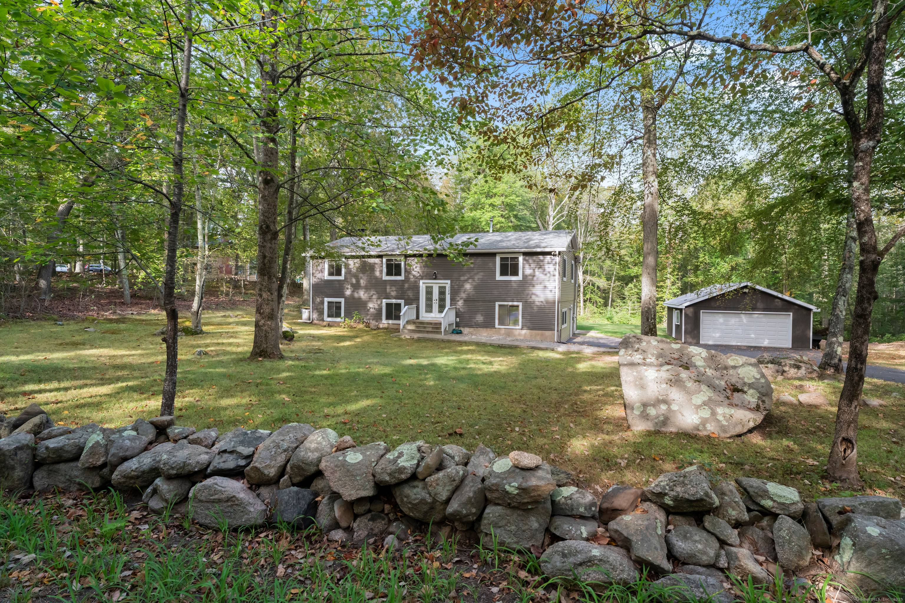 Welcome to this beautifully remodeled and expanded 5 bedroom raised ranch at 1028 Moose Hill Road in Guilford.