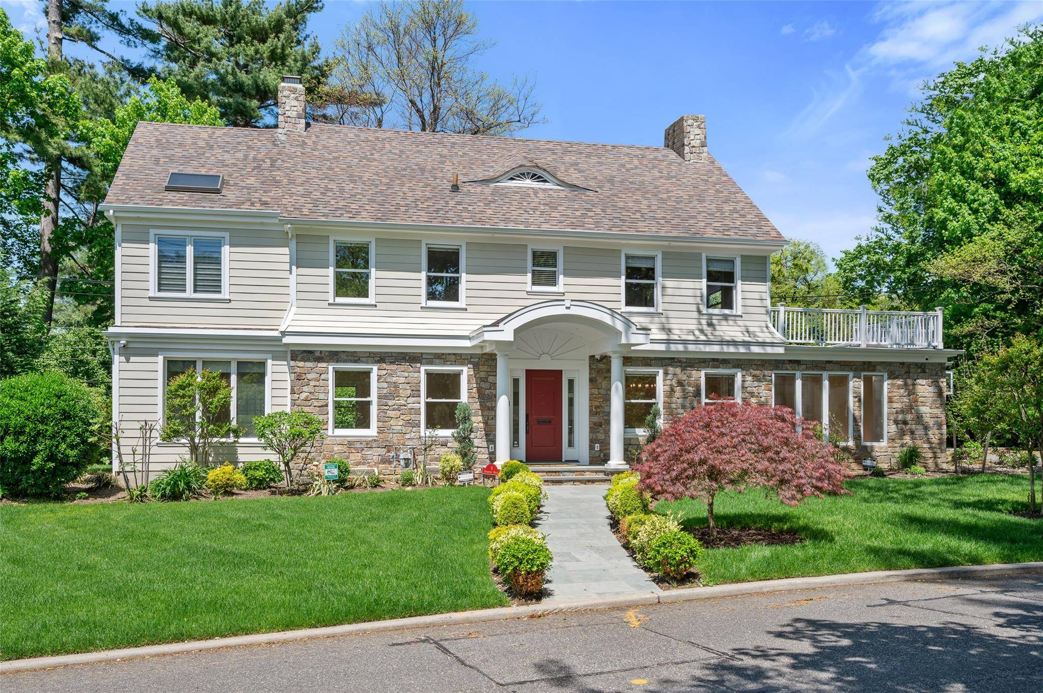 Discover refined living in this distinguished Center Hall Colonial, perfectly positioned on a coveted corner lot in prestigious Great Neck Estates.