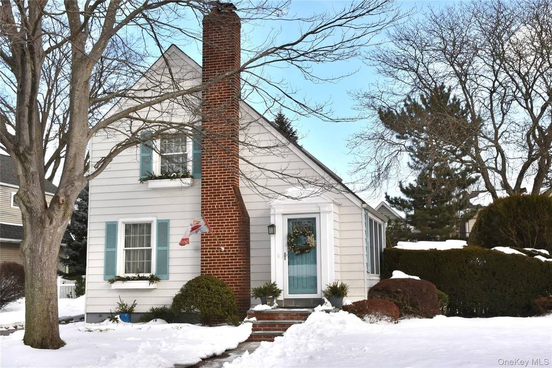 This beautiful colonial style home is situated on an expansive picturesque tree lined street in the historic Village of Garden City.