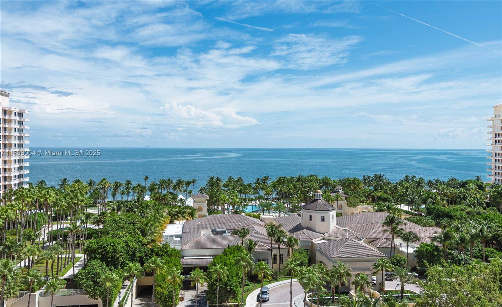 Experience refined island living in this exquisitely remodeled corner residence at The Ocean Club, showcasing breathtaking sunsets and the glittering Miami skyline.