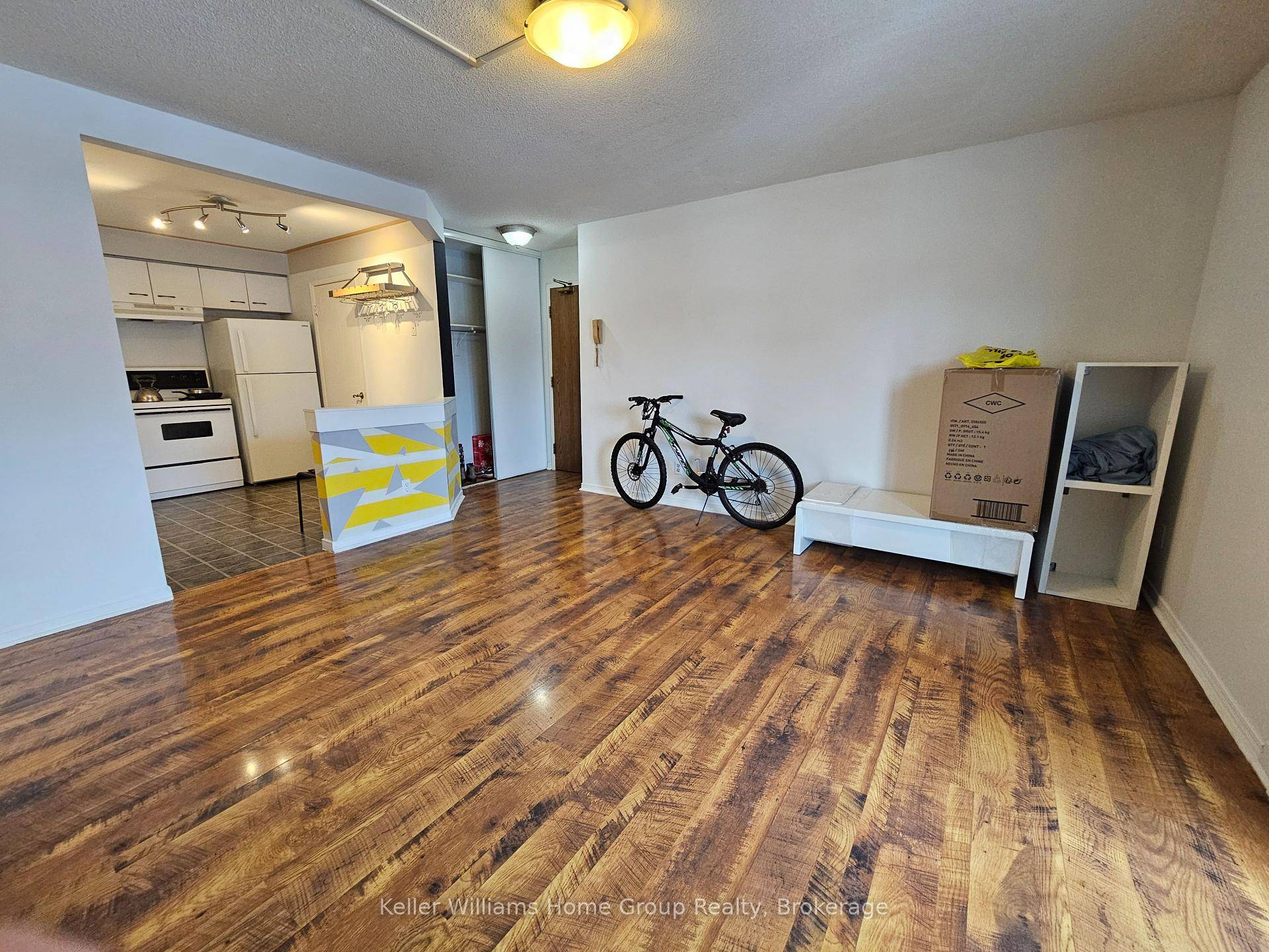 Here's a bright, mostly open concept apartment with balcony and some storage.